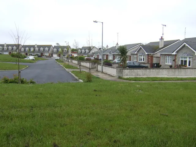 Residential estate street of bungalows and two-storey houses at Donore, Co. Meath, with green in the foreground