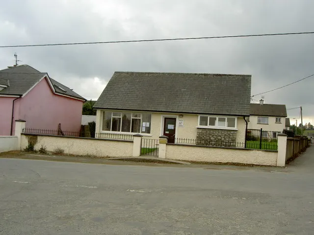 Doctor's surgery in Rathdrum, Co. Wicklow: bungalow GP surgery with HSE plaque beside a pink house