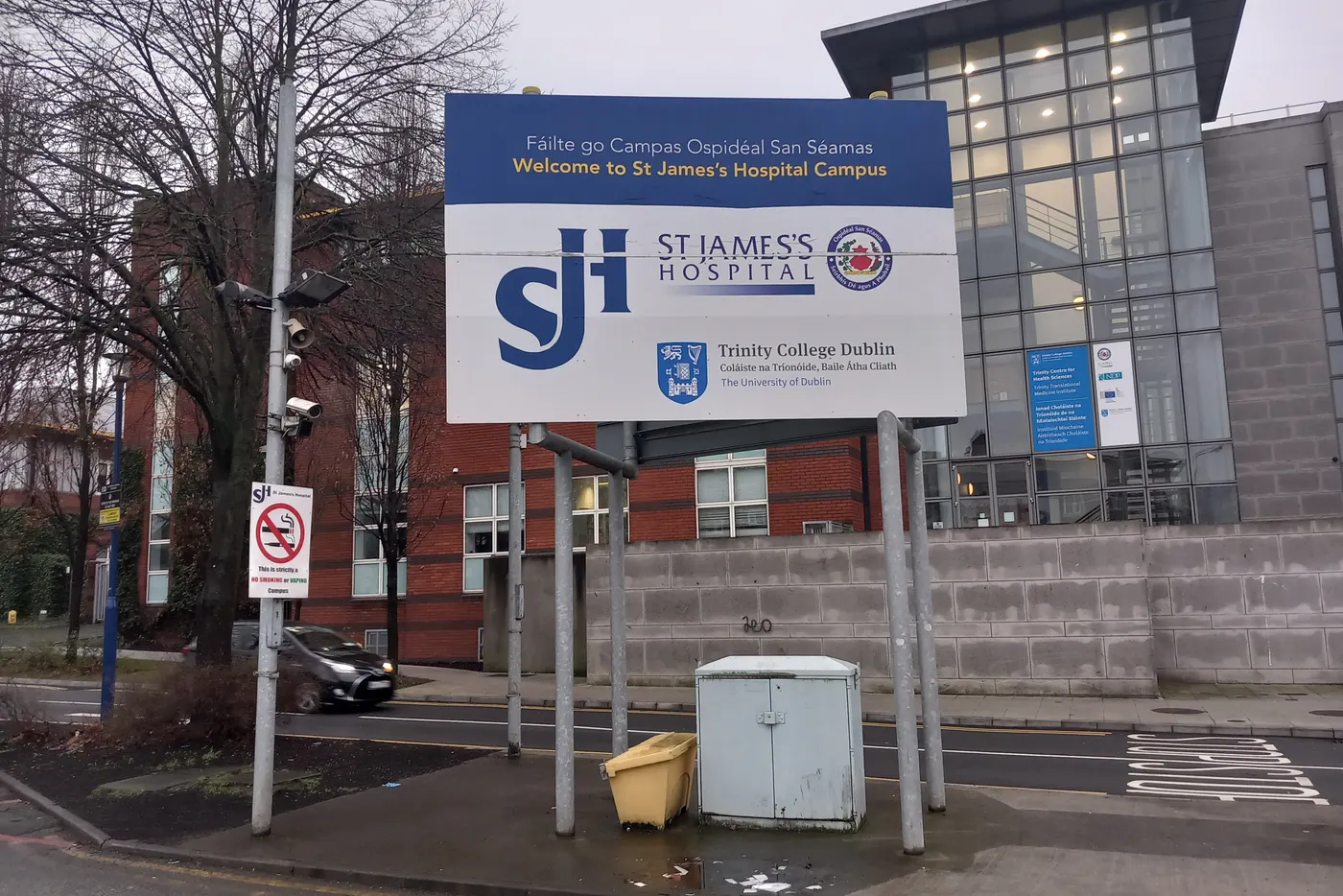 Welcome sign at the main entrance to St James's Hospital campus, Dublin (home of the GUIDE sexual health clinic), with hospital buildings behind
