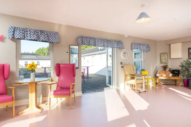 Beechwood Nursing Home, Leighlinbridge, Co. Carlow: interior day room with pink armchairs and open doors onto a courtyard, no people