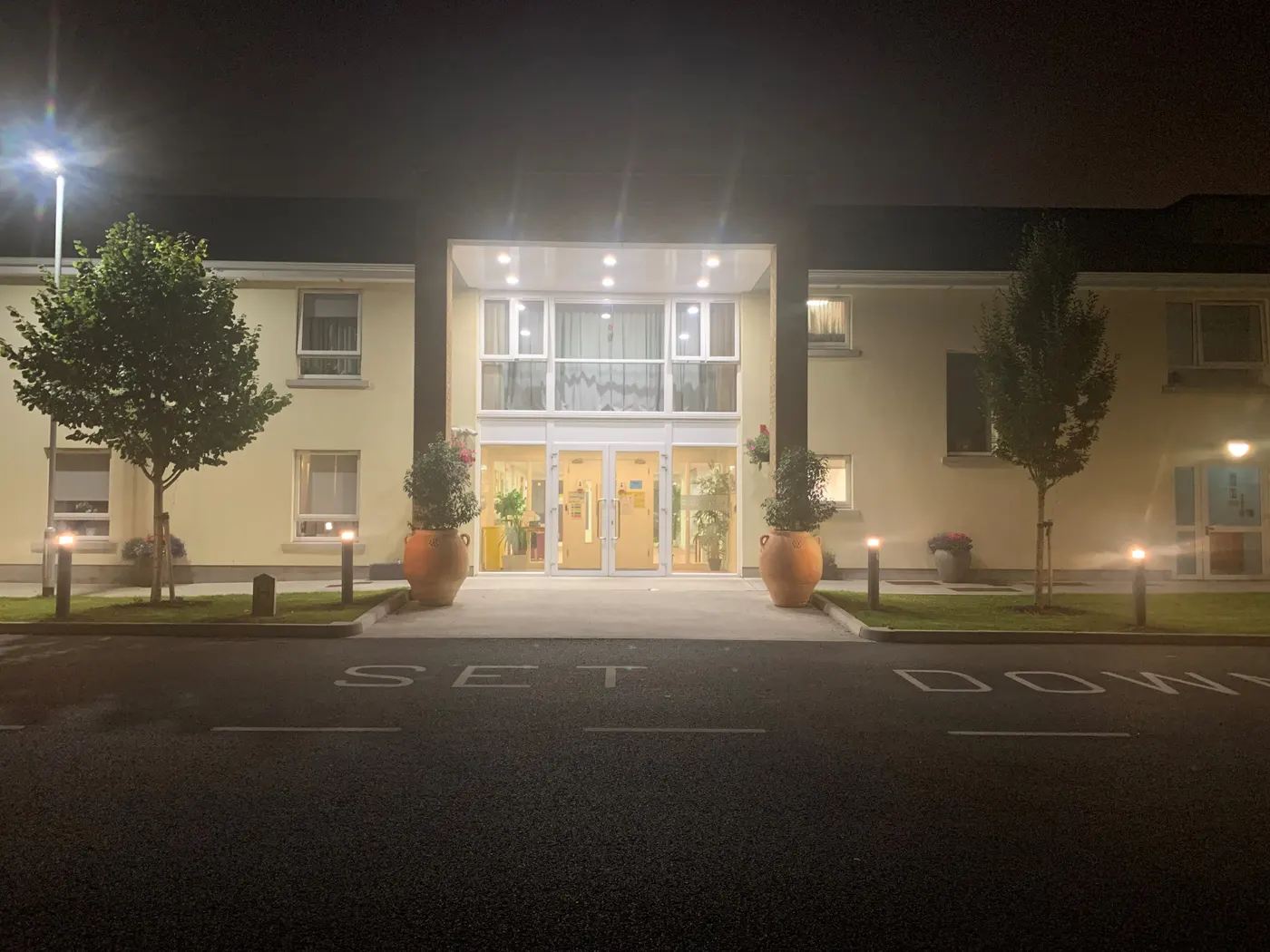 Clearbrook Nursing Home, Finglas West, Co. Dublin: front entrance lit up at night, set-down bay in front, no people