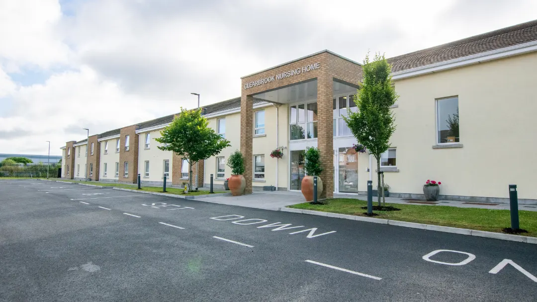 Clearbrook Nursing Home, Finglas West, Co. Dublin: angled view along the front of the building showing the entrance sign and the length of the two-storey block, no people