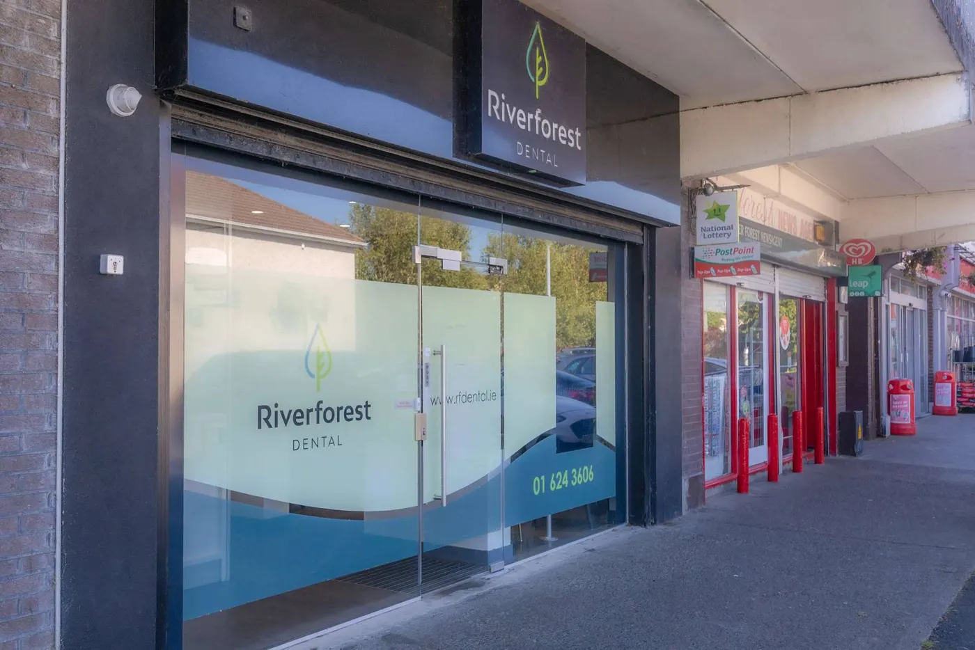 Riverforest Dental, Leixlip, Co. Kildare: Riverforest Dental shopfront exterior with branded frosted glass door, signage and the neighbouring newsagent.
